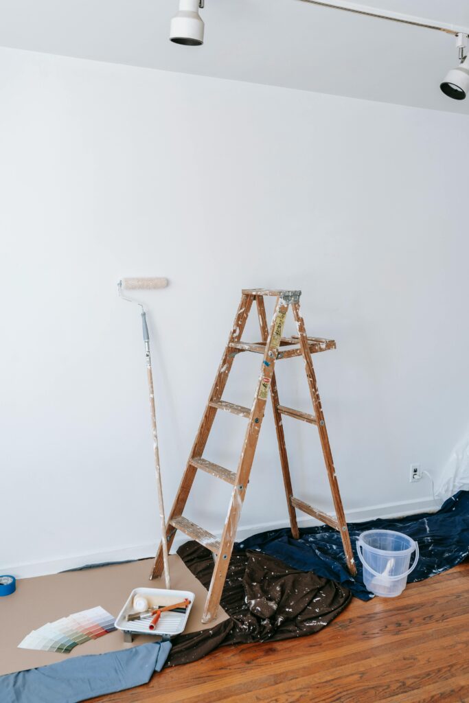 A minimalistic interior design scene with painting tools ready for a room renovation project.